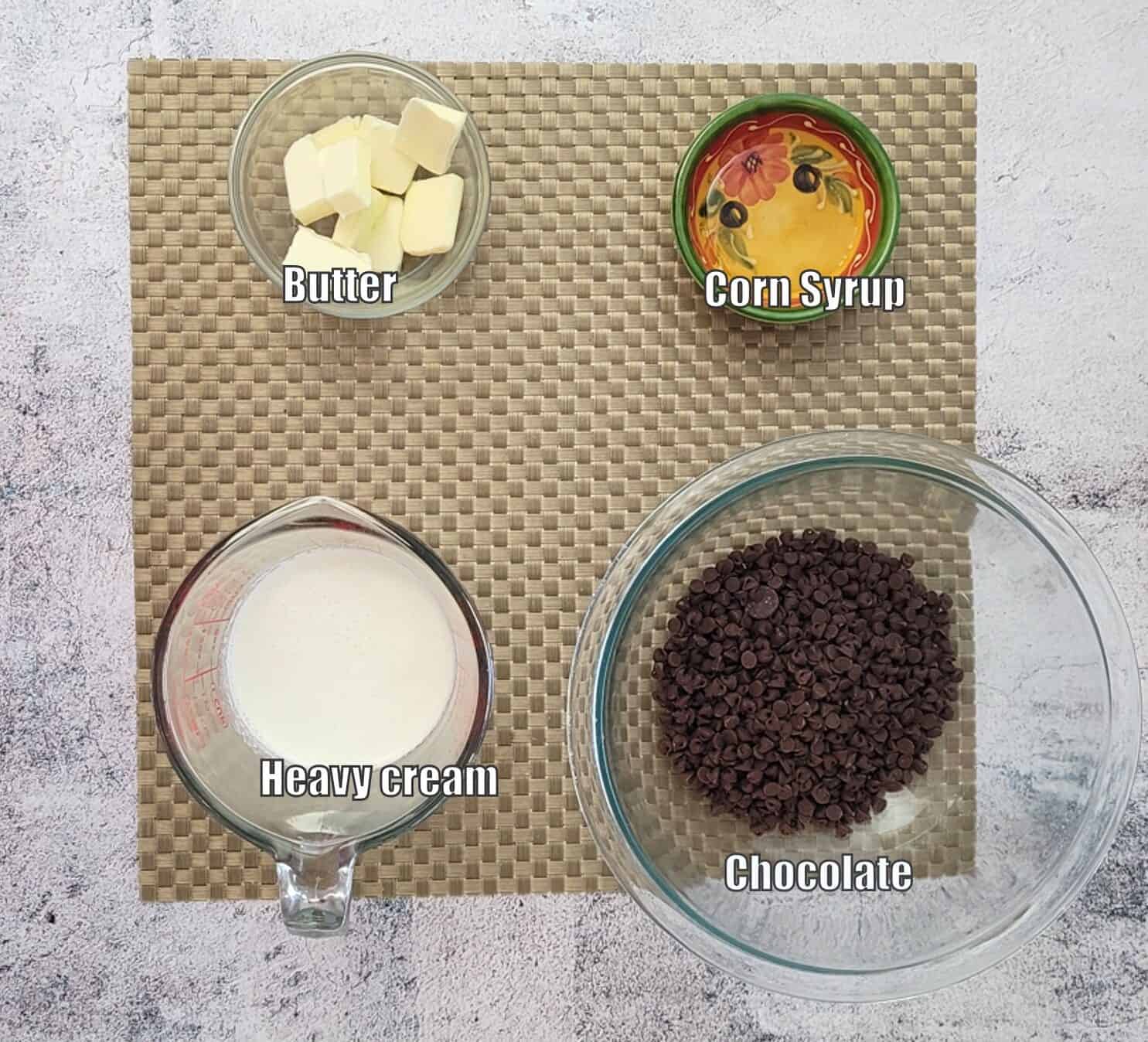 ingredients needed to make fudge icing recipe including chocolate, cream, corn syrup and butter