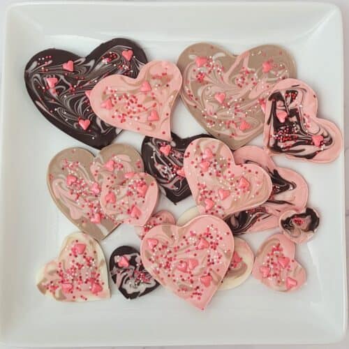 overhead view of heart shaped Valentines chocolate bark on a serving platter