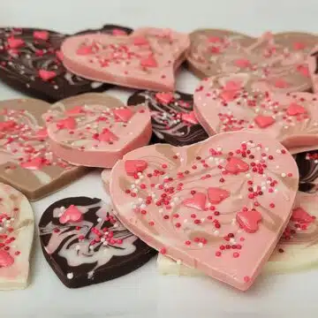 heart shaped Valentine's Day chocolate bark with pink, cream, chocolate and white swirls and sprinkles