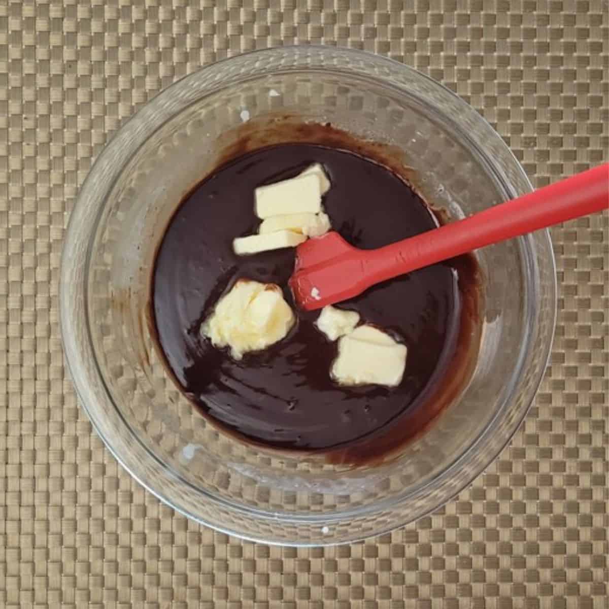 butter added to bowl to make chocolate frosting