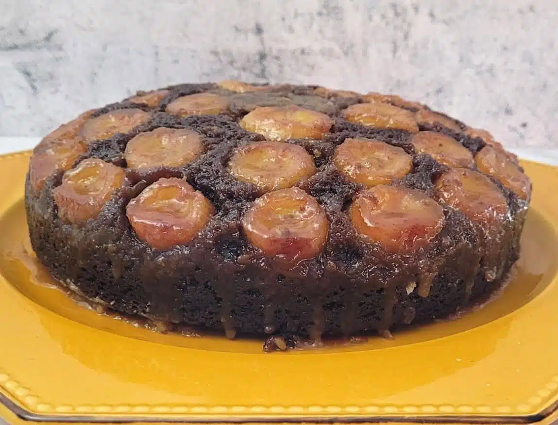 close up view of cake showing detail of banana and caramel topping