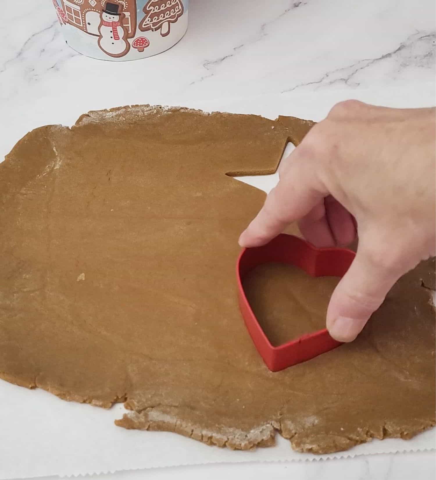 cutting out Christmas shaped cookies to make edible wreath