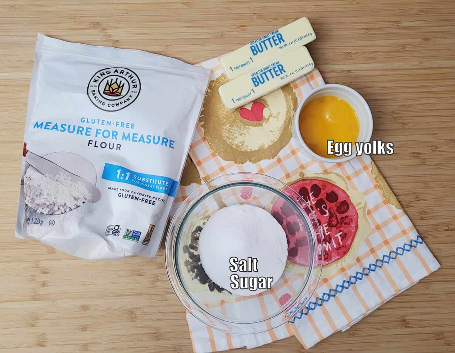 ingredients needed to make pie dough including salt, sugar, egg yolks, butter and gluten free flour