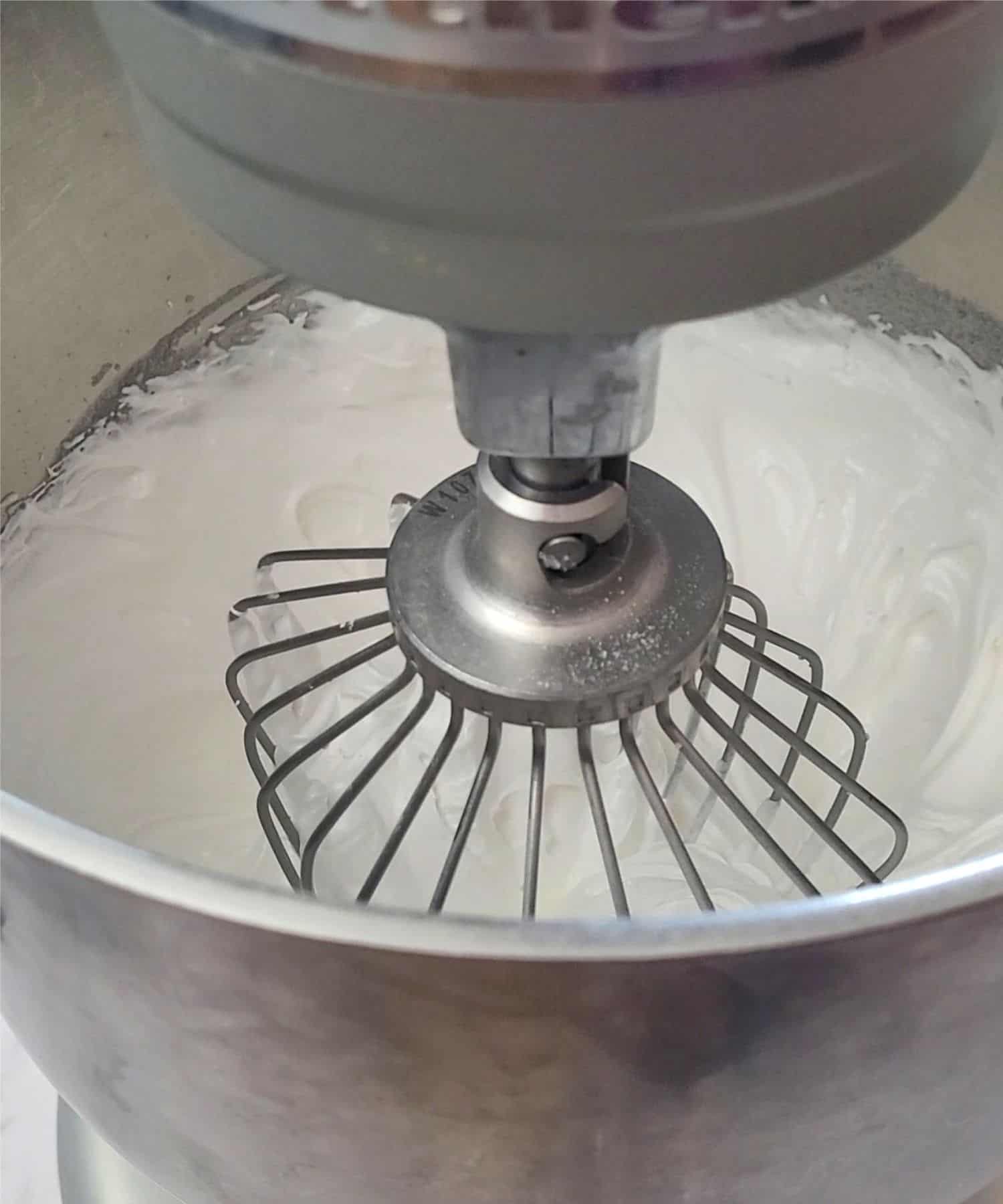 egg whites whipped to stiff peaks in a mixing bowl