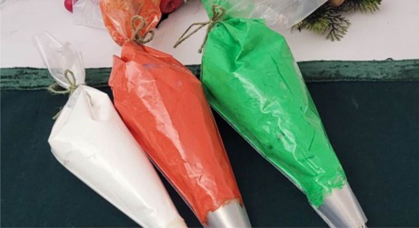 pastry bags filled with green, red and white royal icing