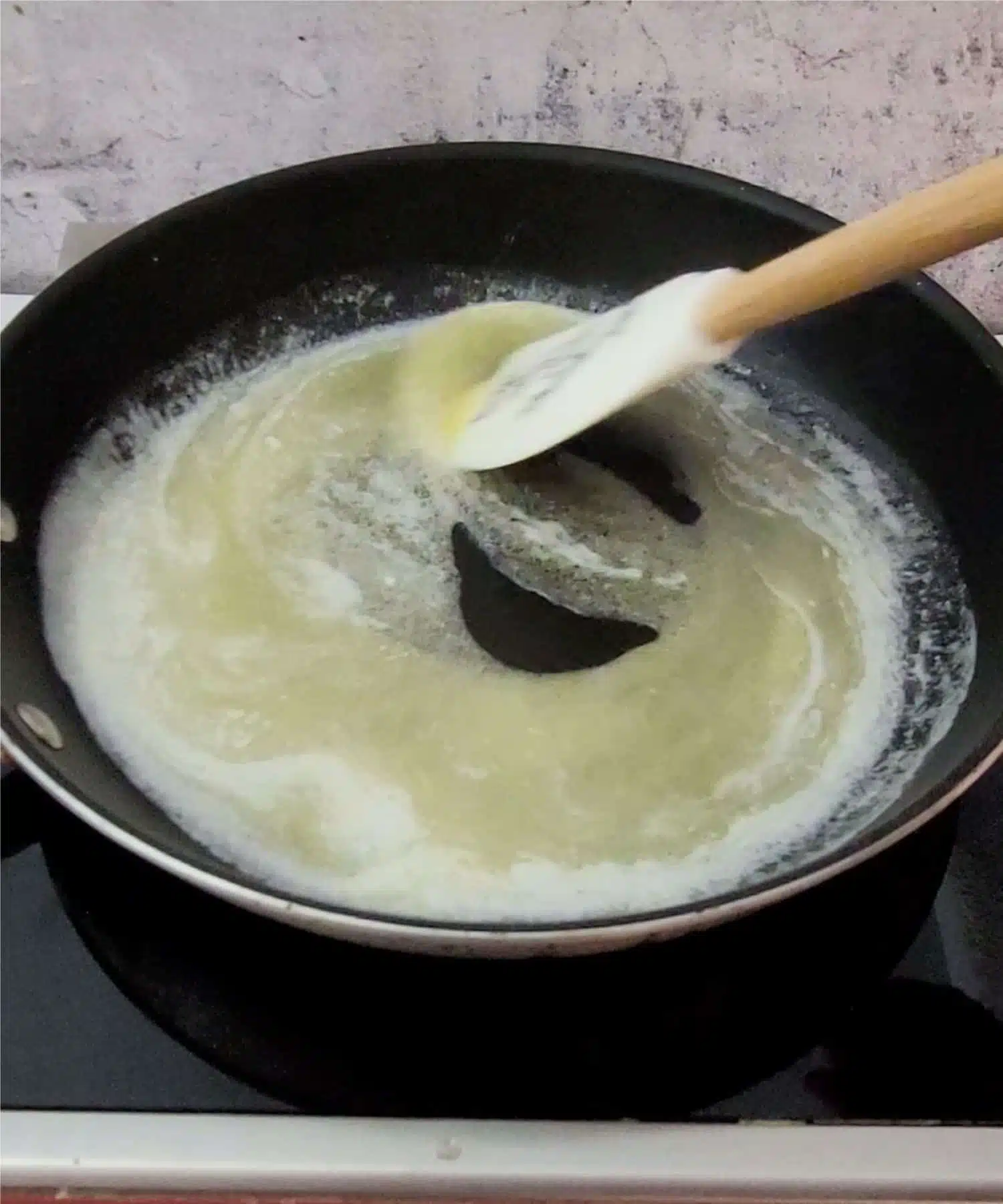 melting butter in a saucepan over a stovetop