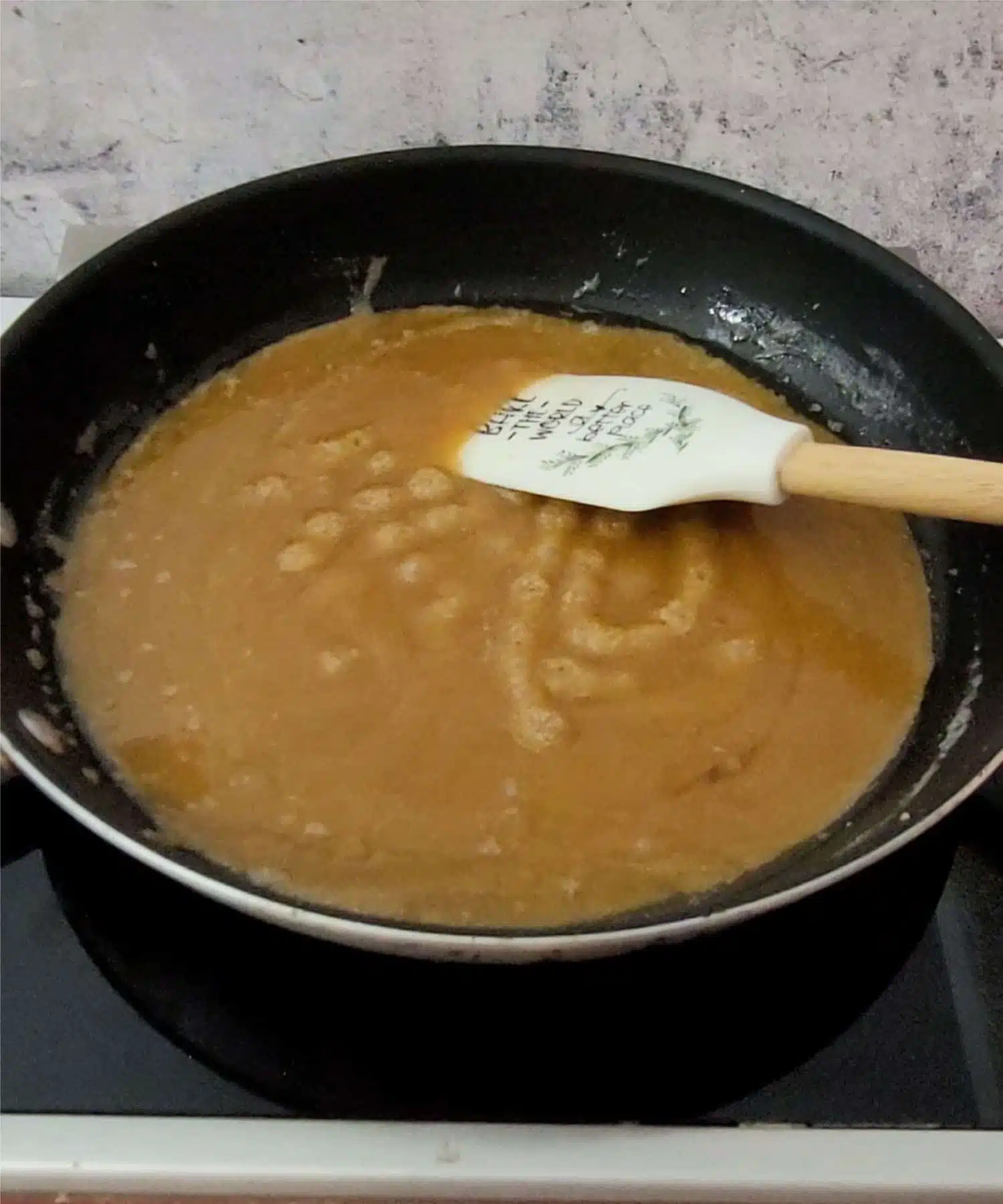 brown sugar and butter boiling in a saucepan to make topping for chocolate banana upside down cake