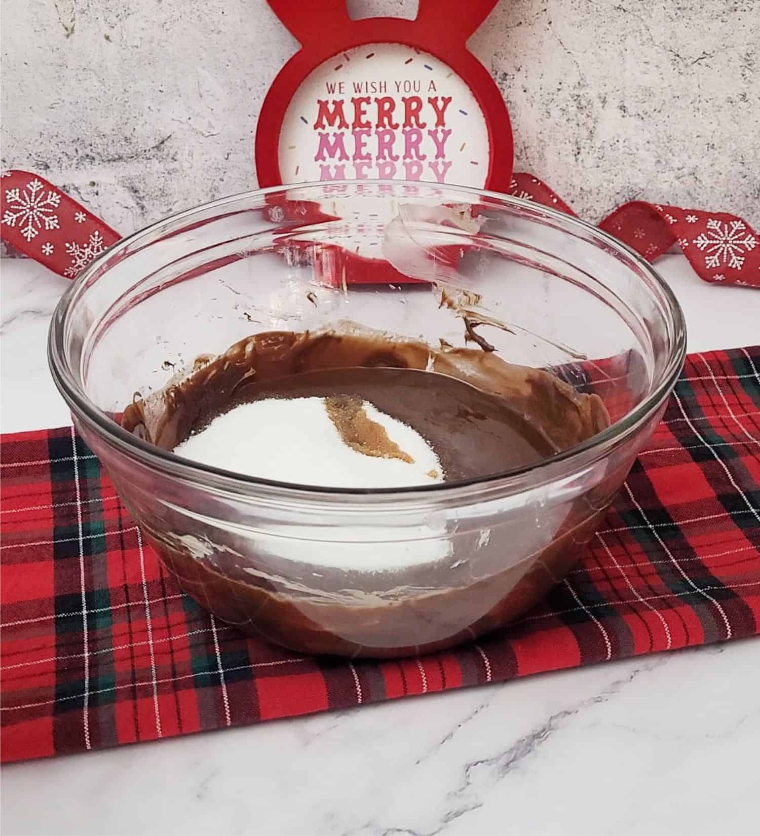 vanilla and sugar added to mixing bowl to make batter for flourless Christmas cake