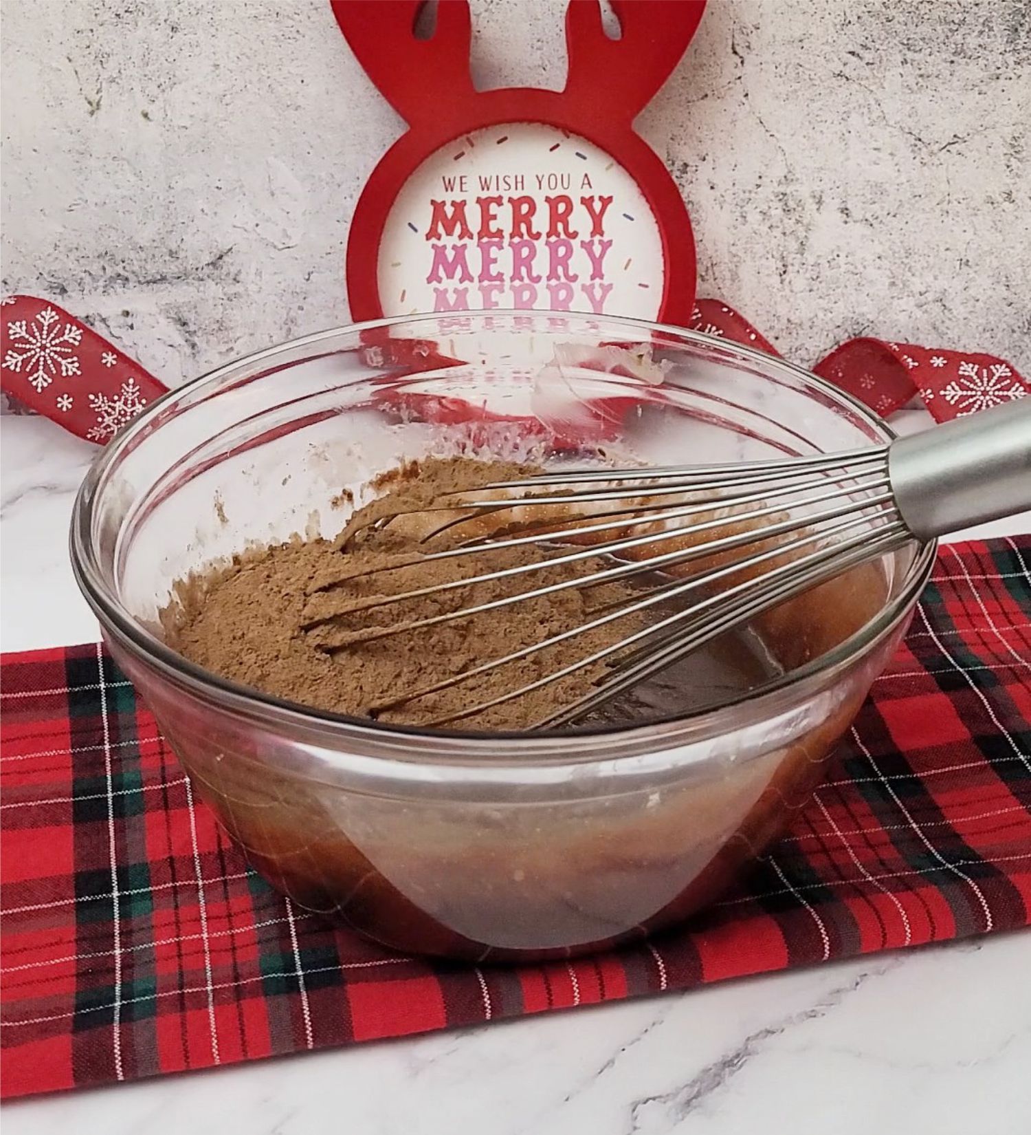 cocoa powder added to mixing bowl to make a flourless chocolate Christmas cake