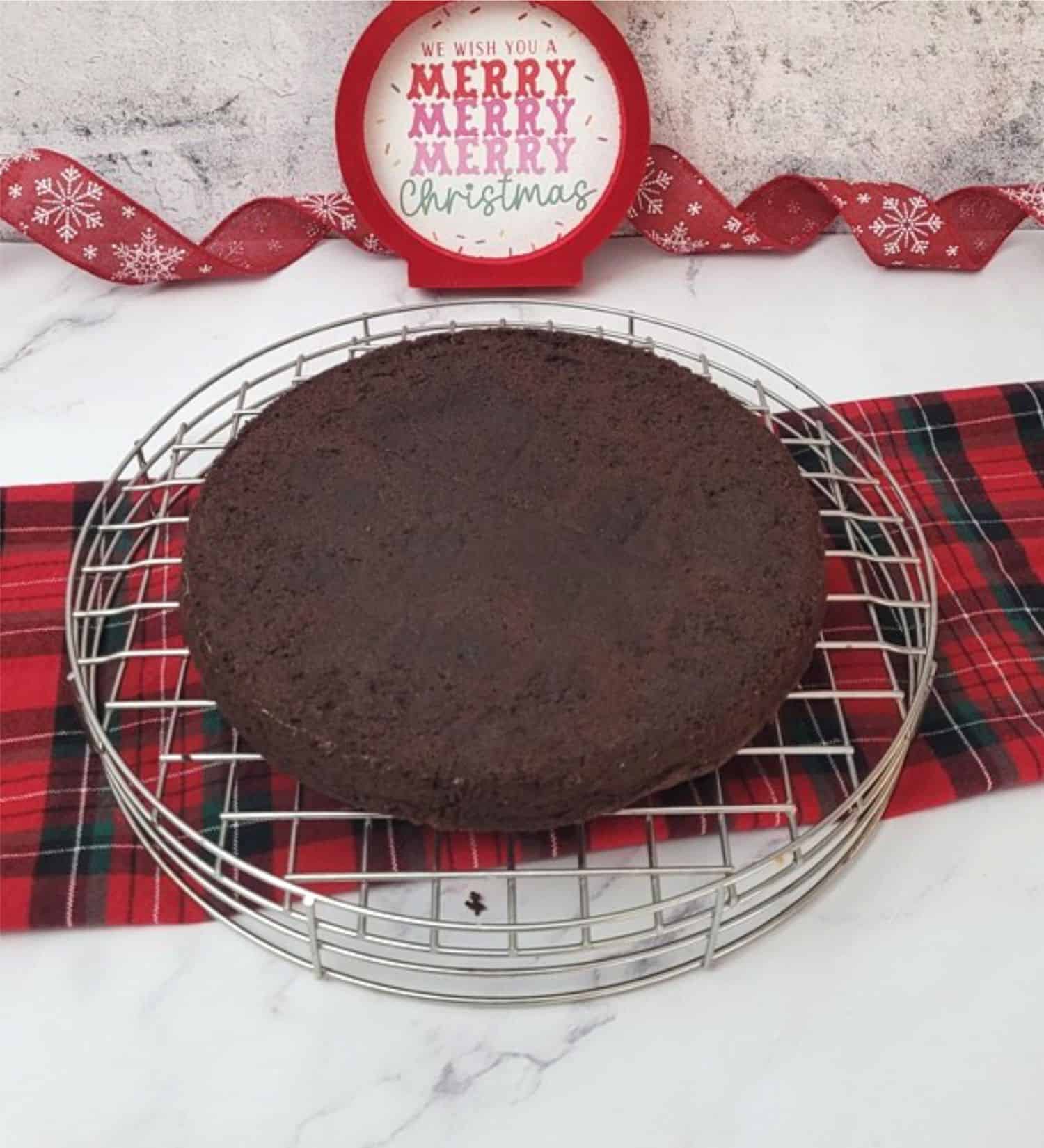 gluten free chocolate Christmas cake cooling on a wire rack