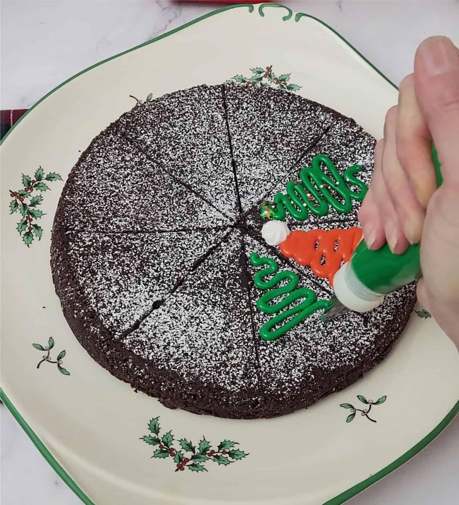 piping a Christmas tree on a cake slice