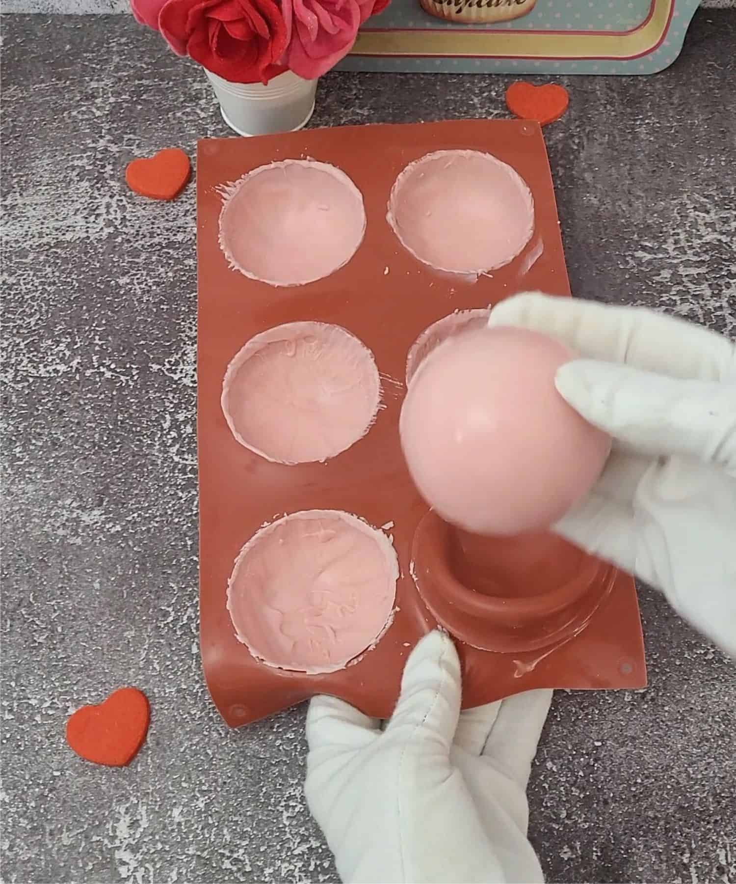 popping pink chocolate domes out of mold after setting