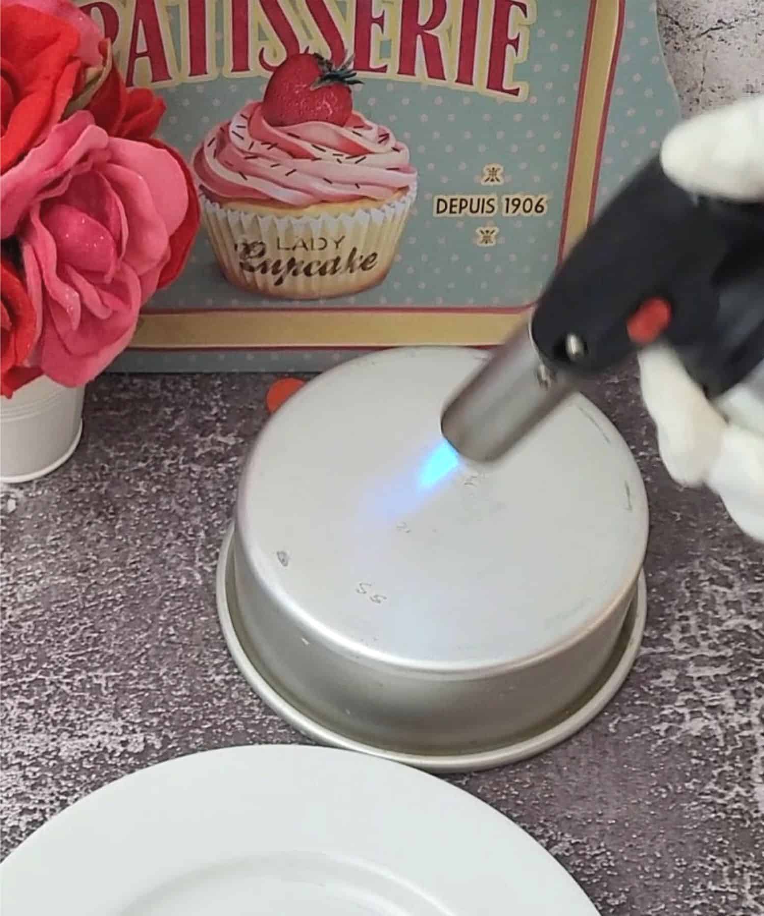 using a kitchen torch to heat a pan to melt tops and bottoms of valentines Nutella mousse bombs