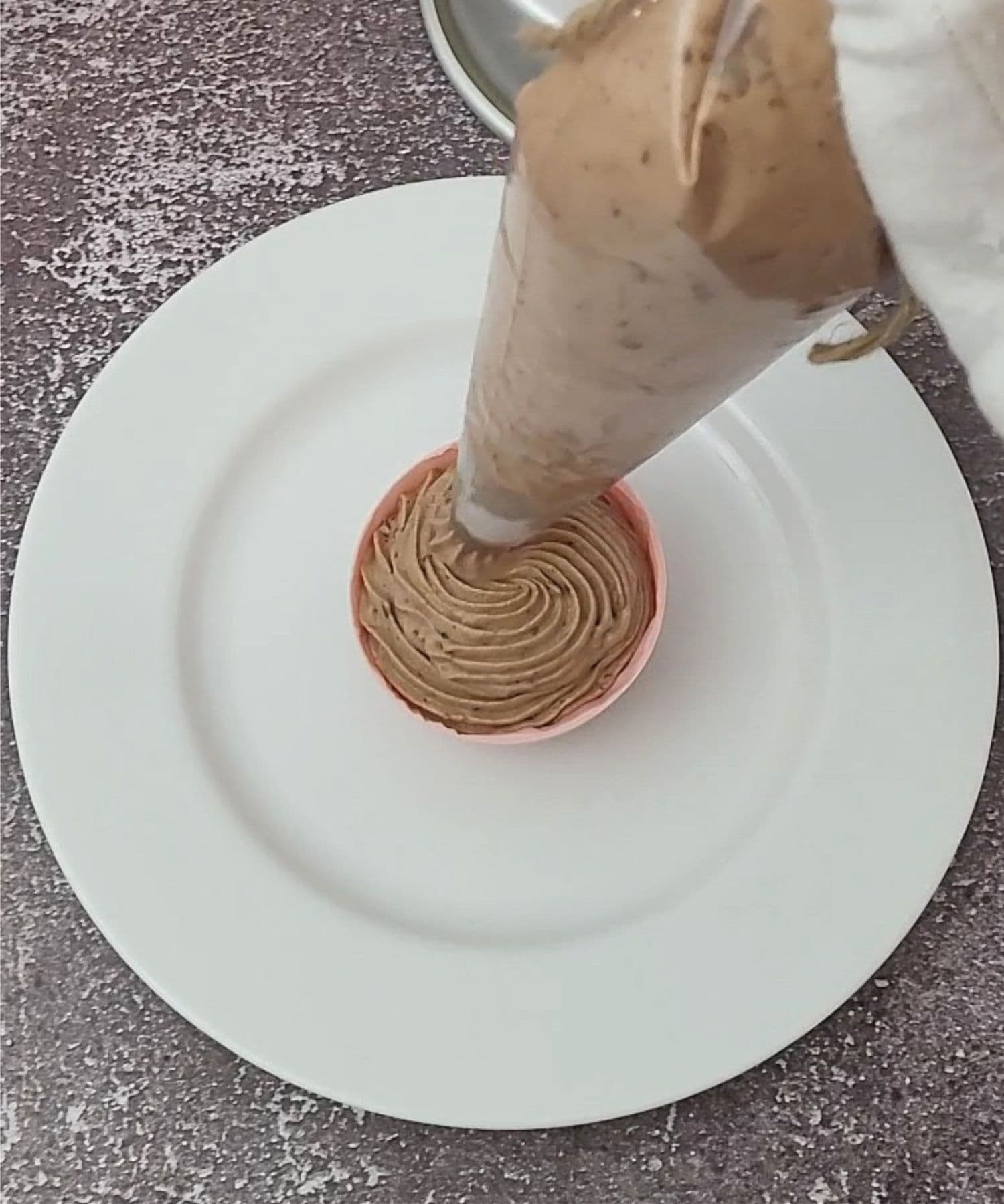 piping Nutella mousse into chocolate half sphere