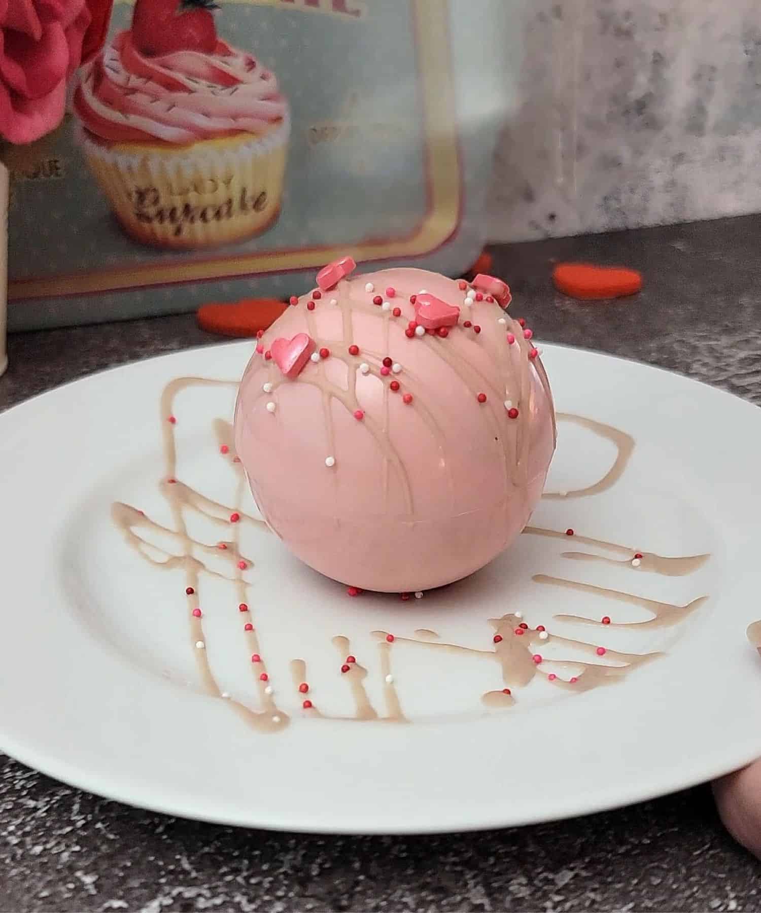 mousse bombs for valentine's day after adding chocolate drizzle and sprinkles