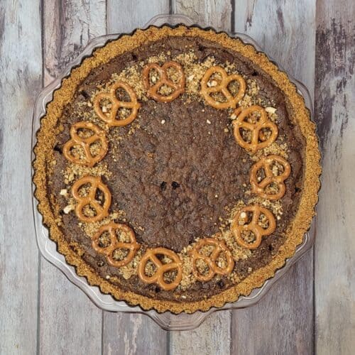 overhead view of a chocolate tart made with a pretzel crust