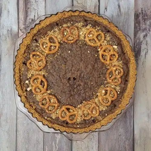 overhead view of a chocolate tart made with a pretzel crust