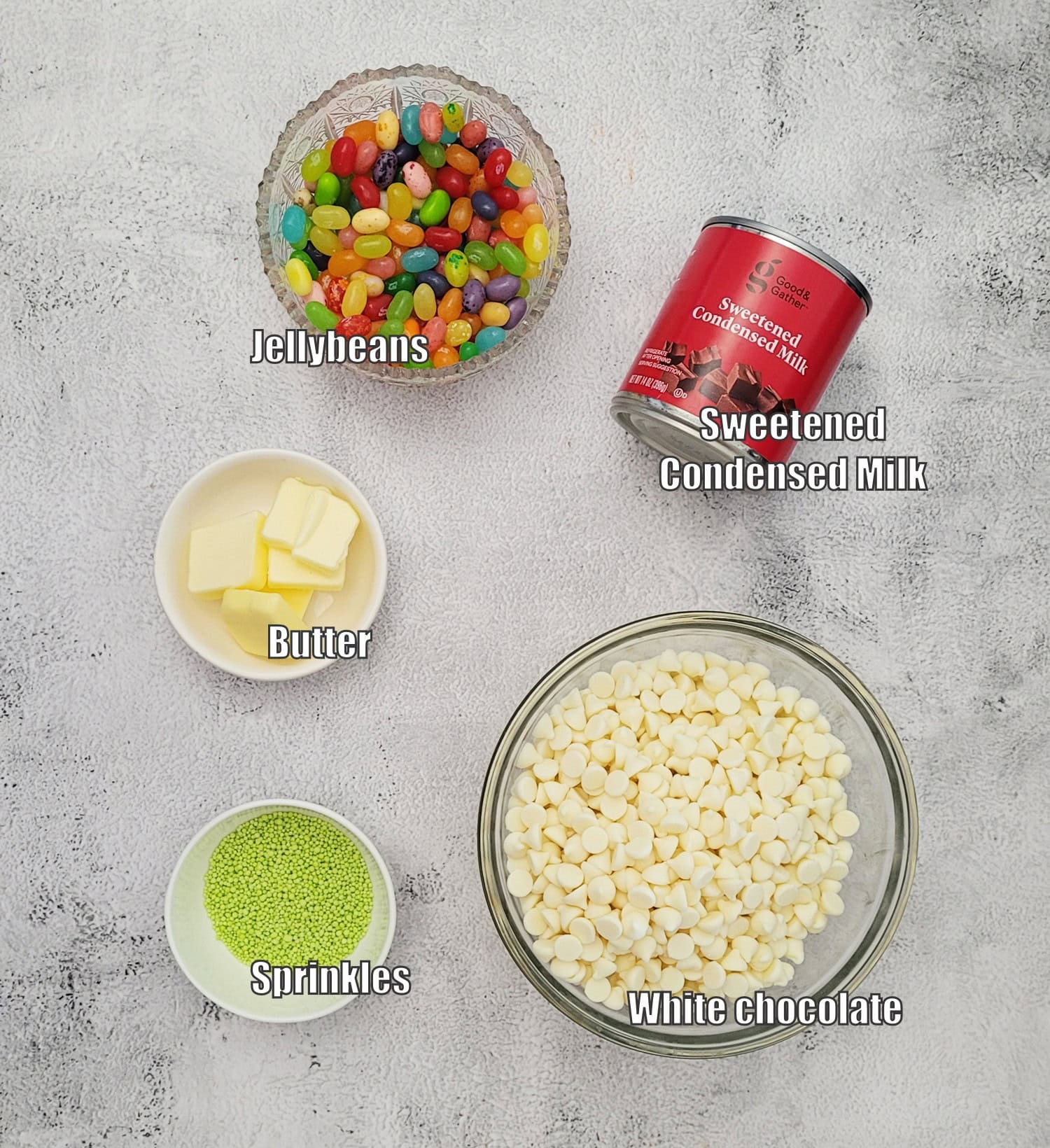 ingredients needed to make Easter jelly bean fudge including white chocolate, sprinkles, jelly beans, condensed milk and butter