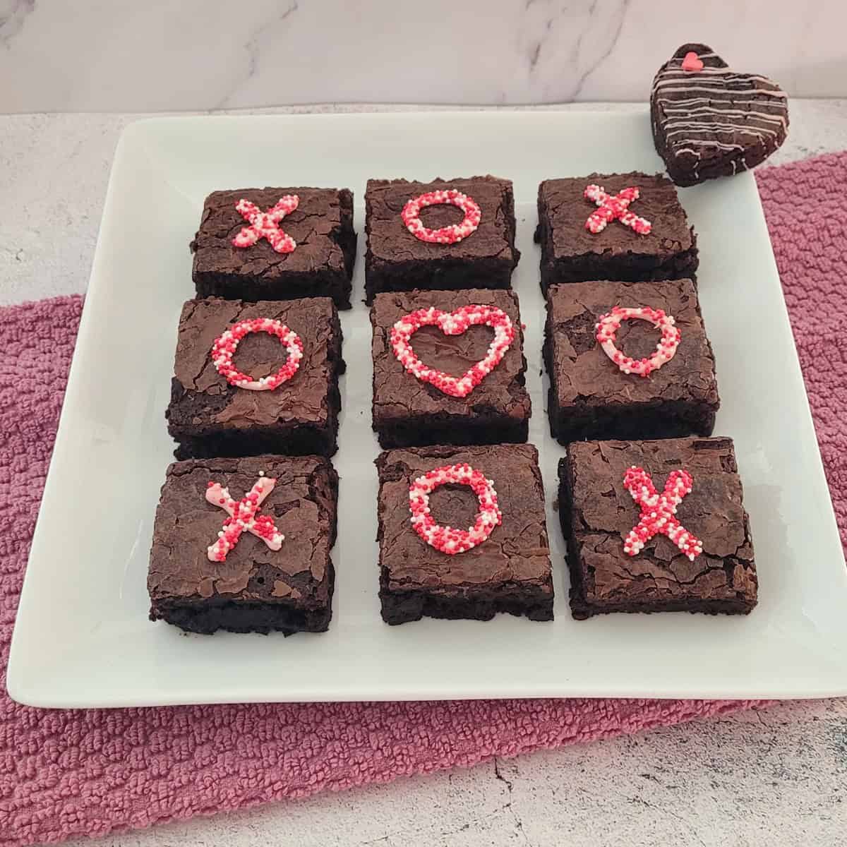 brownies on a serving platter and cut into squares and decorated with Valentine colors