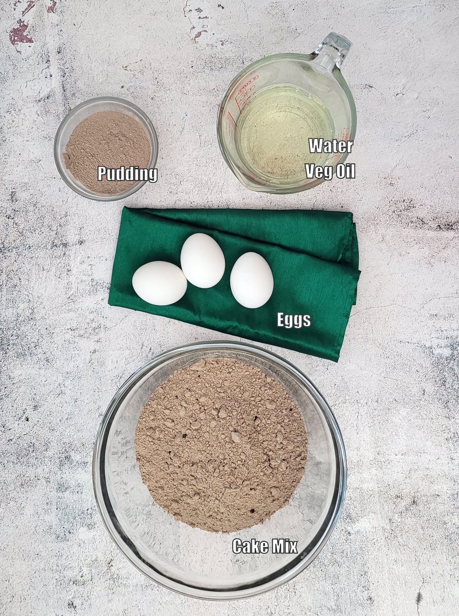 ingredients needed to make football whoopie pies including boxed cake mix, pudding, eggs, oil and water