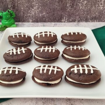 chocolate whoopie pies decorated like footballs on a serving platter