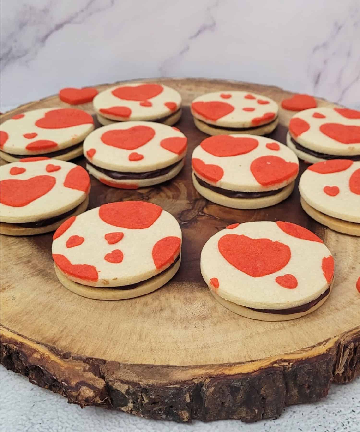 happy valentines day cookies on a wooden serving platter