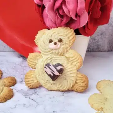 decorated valentine bear cookies on a countertop