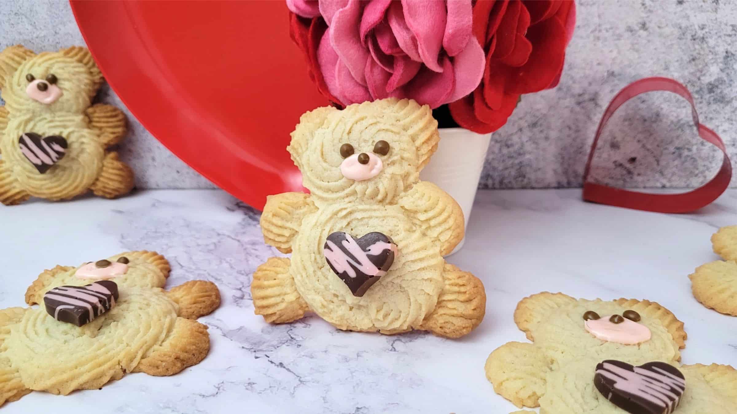 decorated valentine bear cookies on a countertop