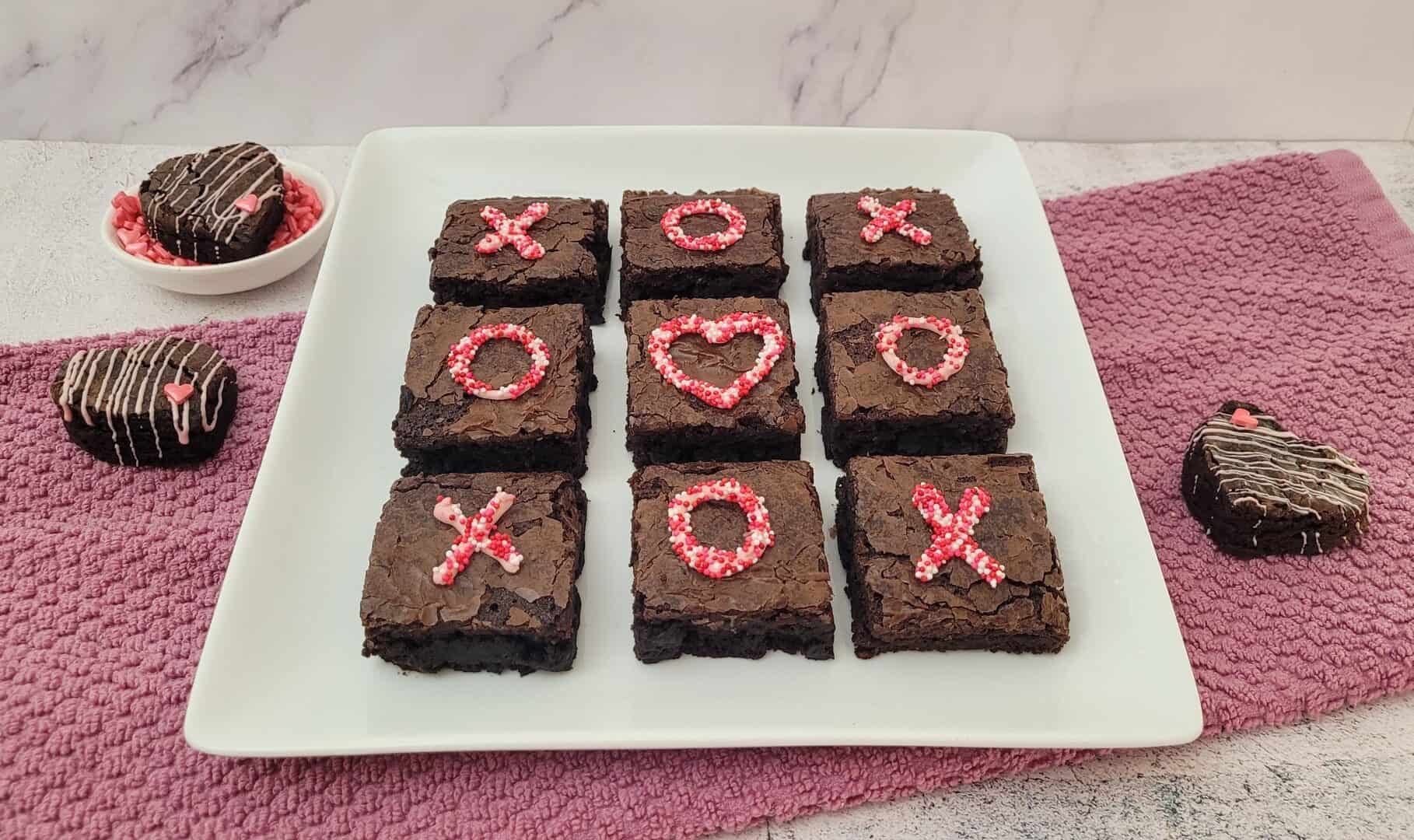 easy valentine's day brownies on a platter with tic tac toe decorations