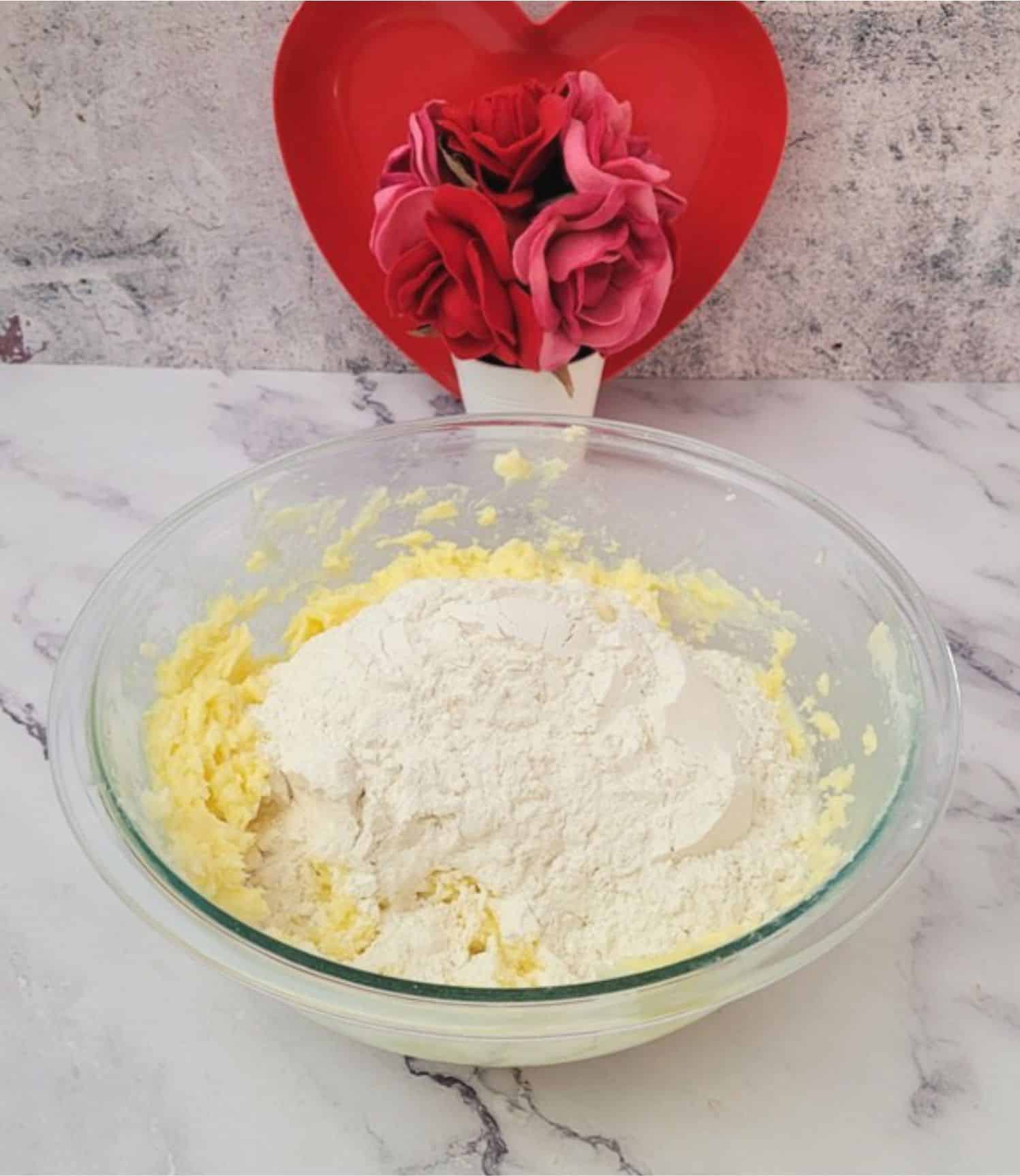 flour and salt added to mixing bowl to make valentine butter cookies