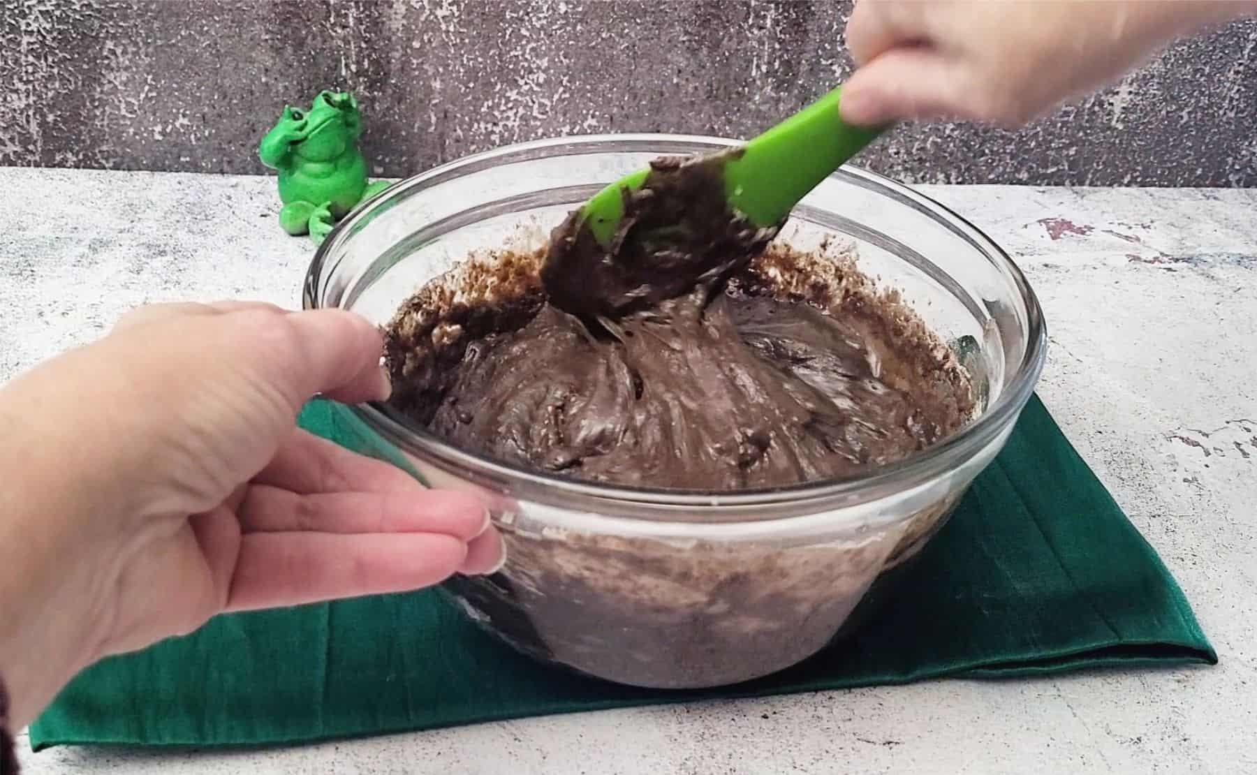 mixing together football whoopie pies from cake mix in a bowl