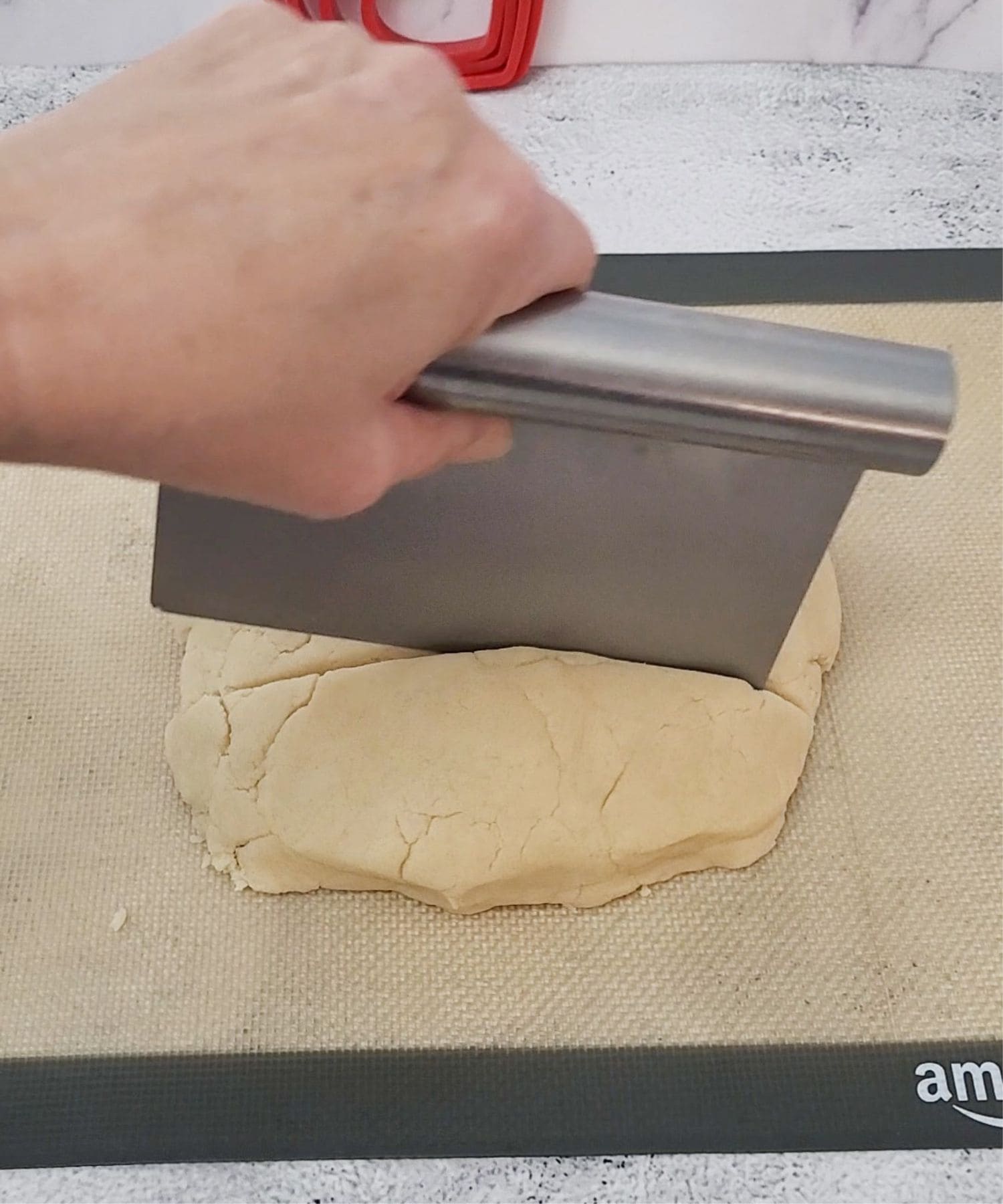 dividing cookie dough to color a small portion of it red for heart inlay