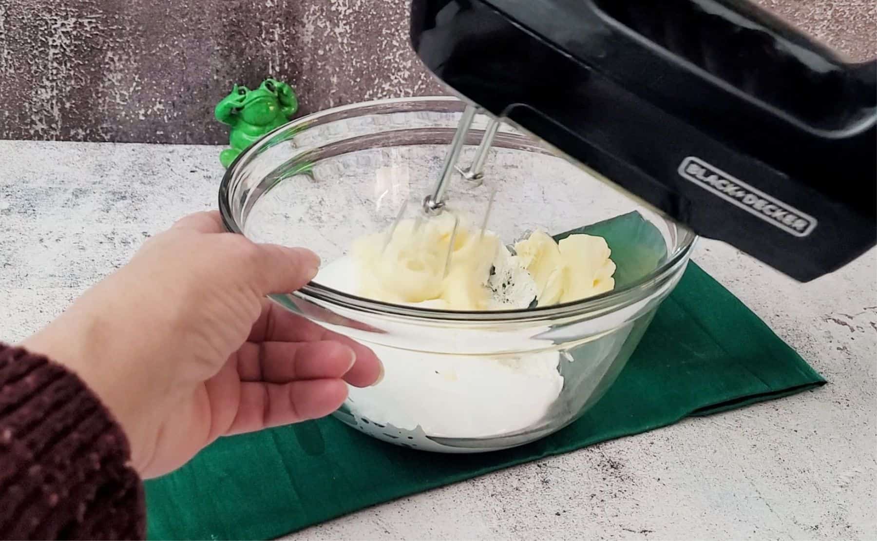 using a hand mixer to mix together marshmallow fluff and butter to make whoopie pie filling