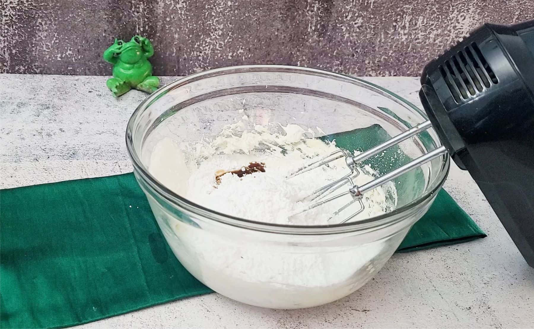 powdered sugar and vanilla extract added to bowl to make filling