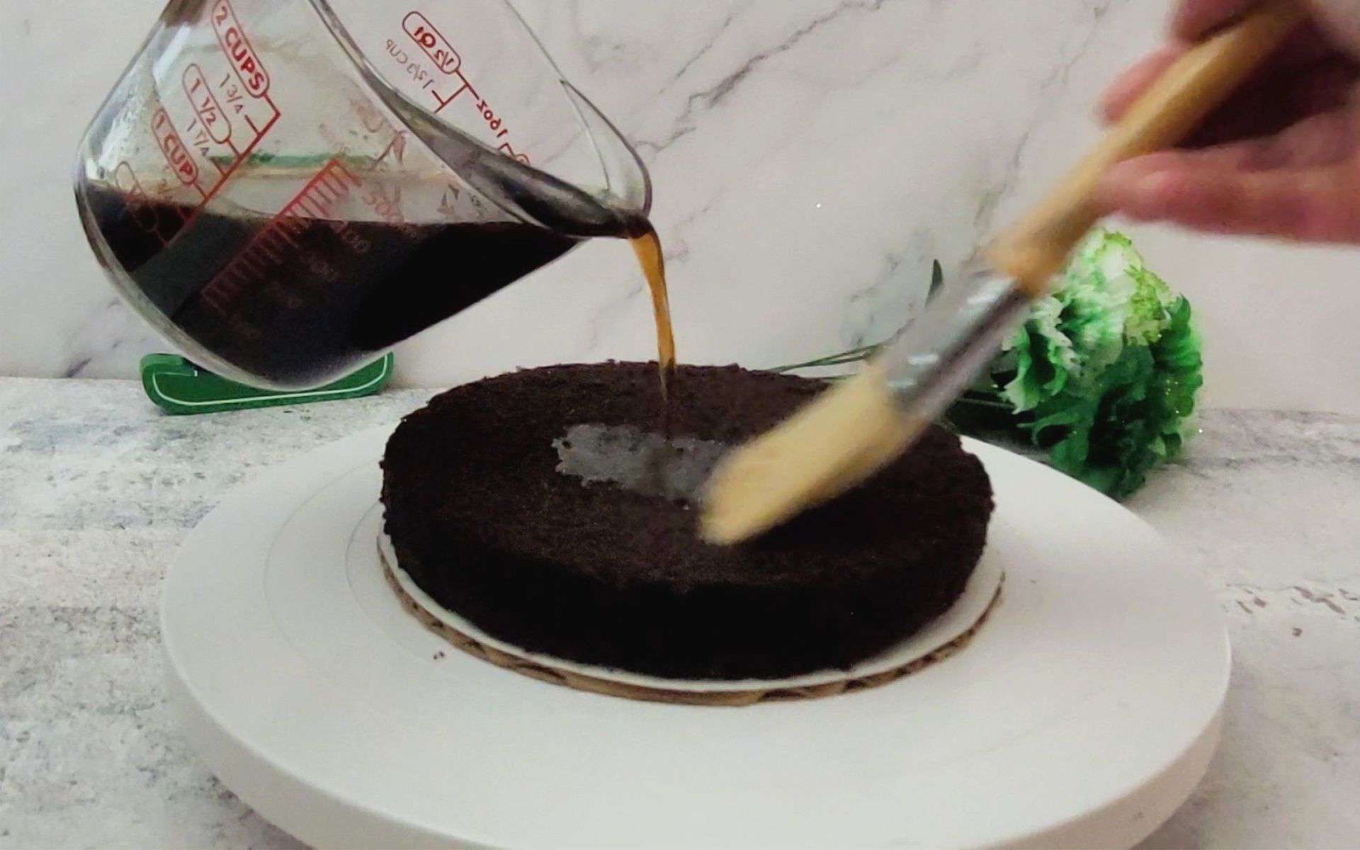 brushing Guinness flavored simple syrup on cake layer