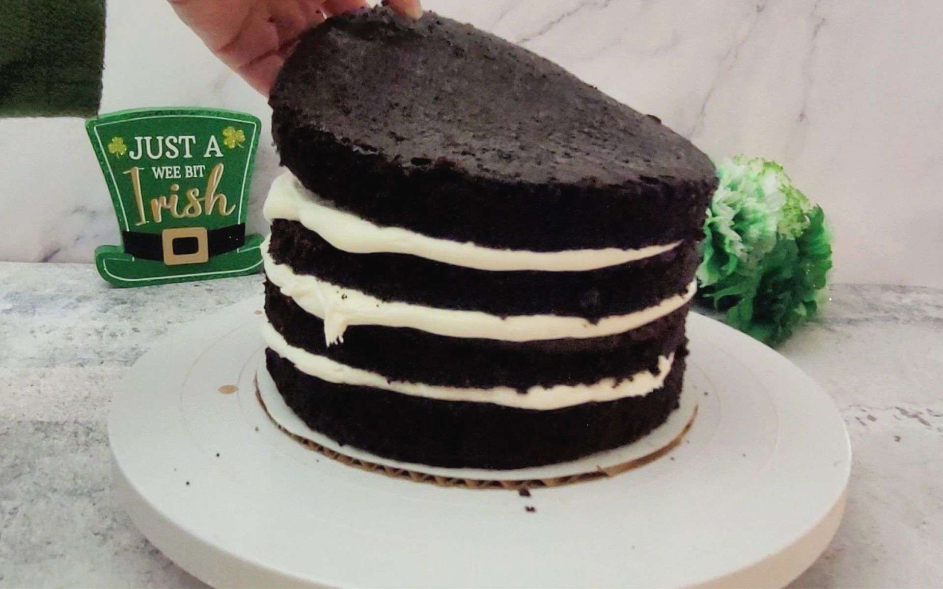 adding final layer of cake to finish stacking