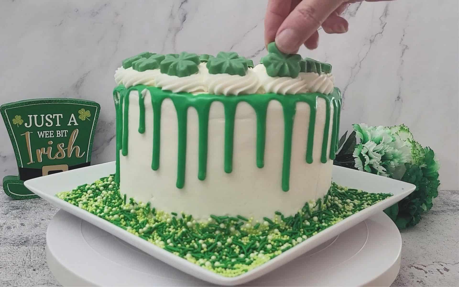 adding final decorating touches to St Patrick's Day chocolate cake with Guinness stout beer