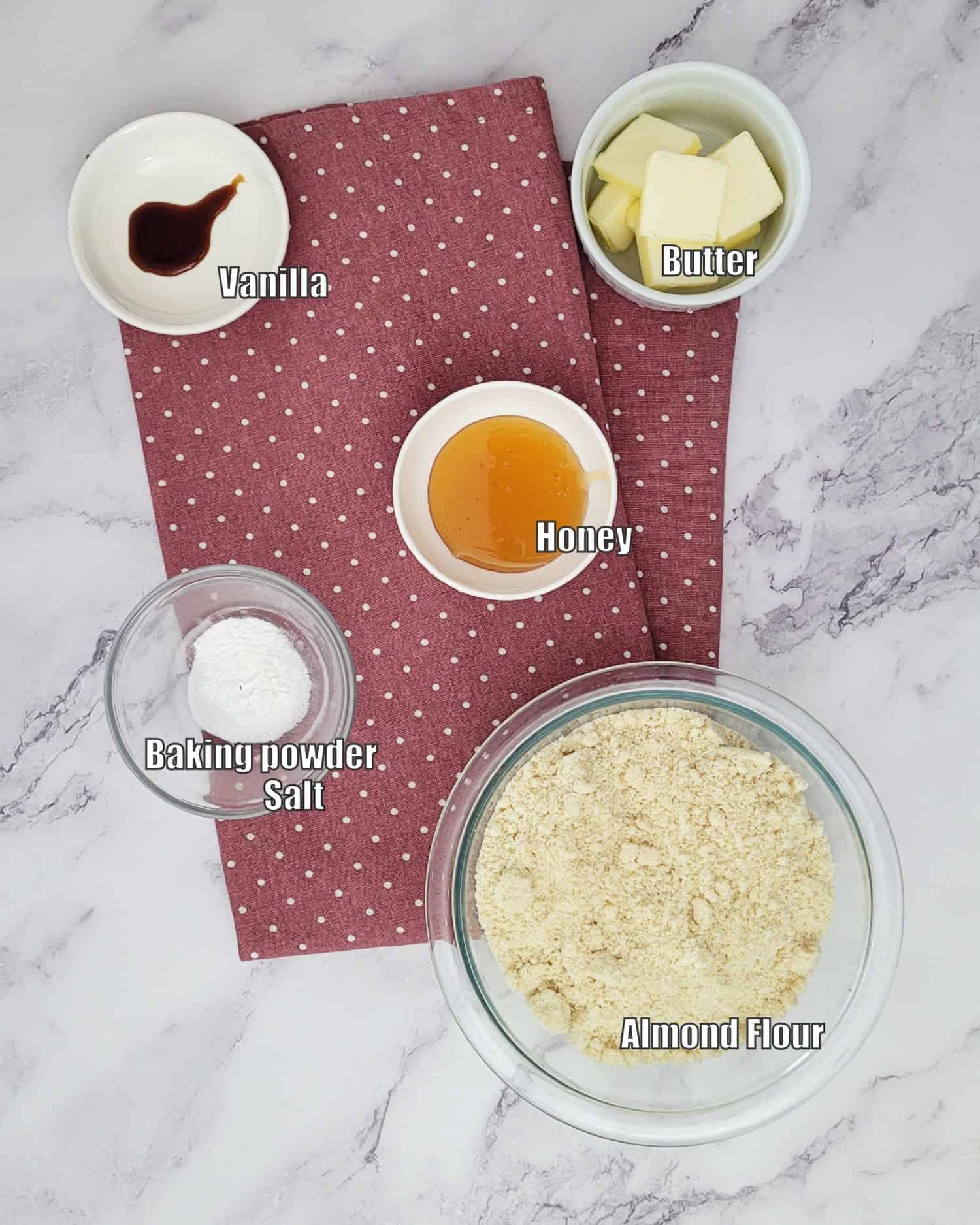 ingredients needed to make easy almond flour cookies including almond flour, honey, salt, baking powder, vanilla and butter