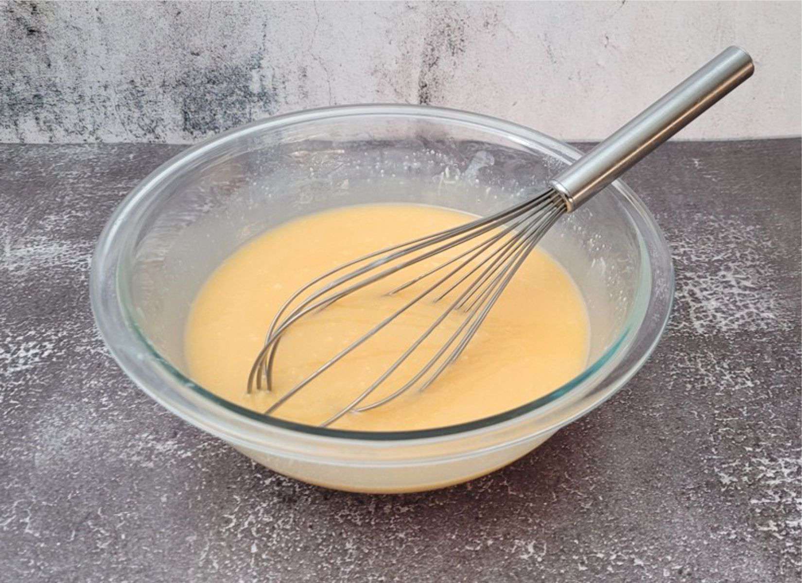 orange food coloring added to mirror glaze in a bowl