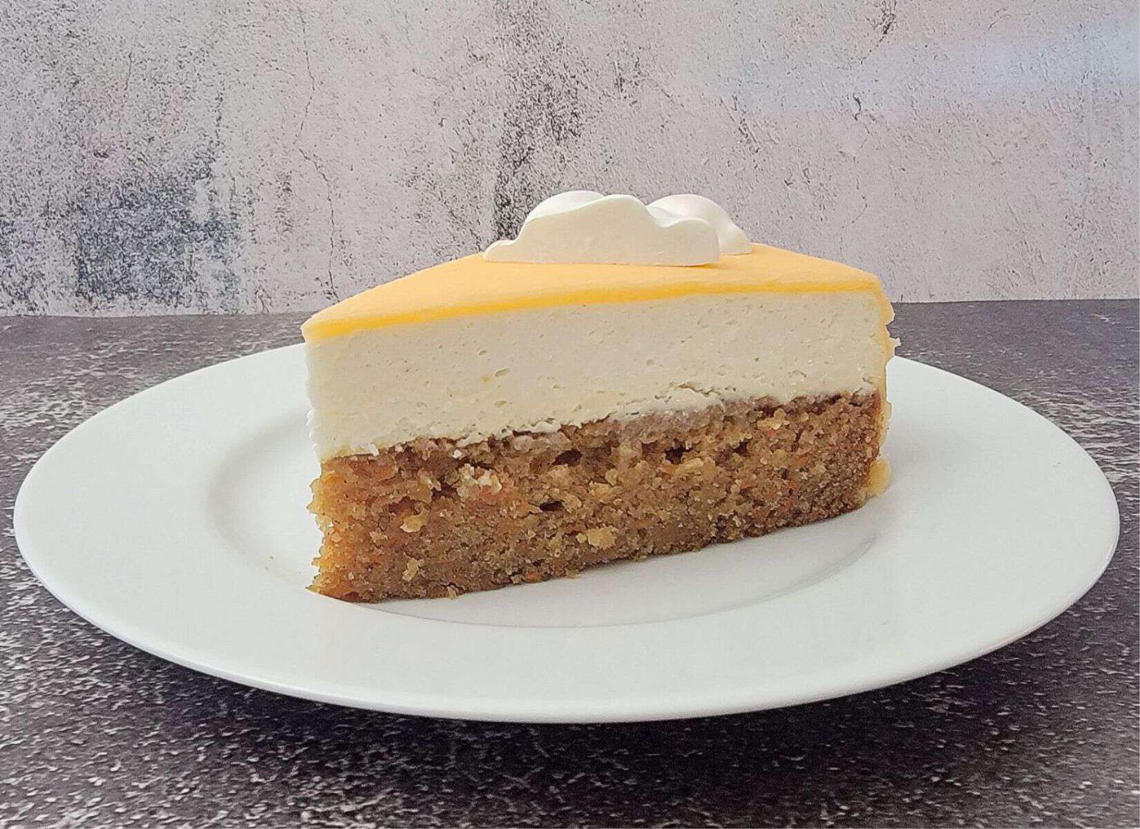 slice of carrot cake with cream cheese mousse on a plate and ready to be served