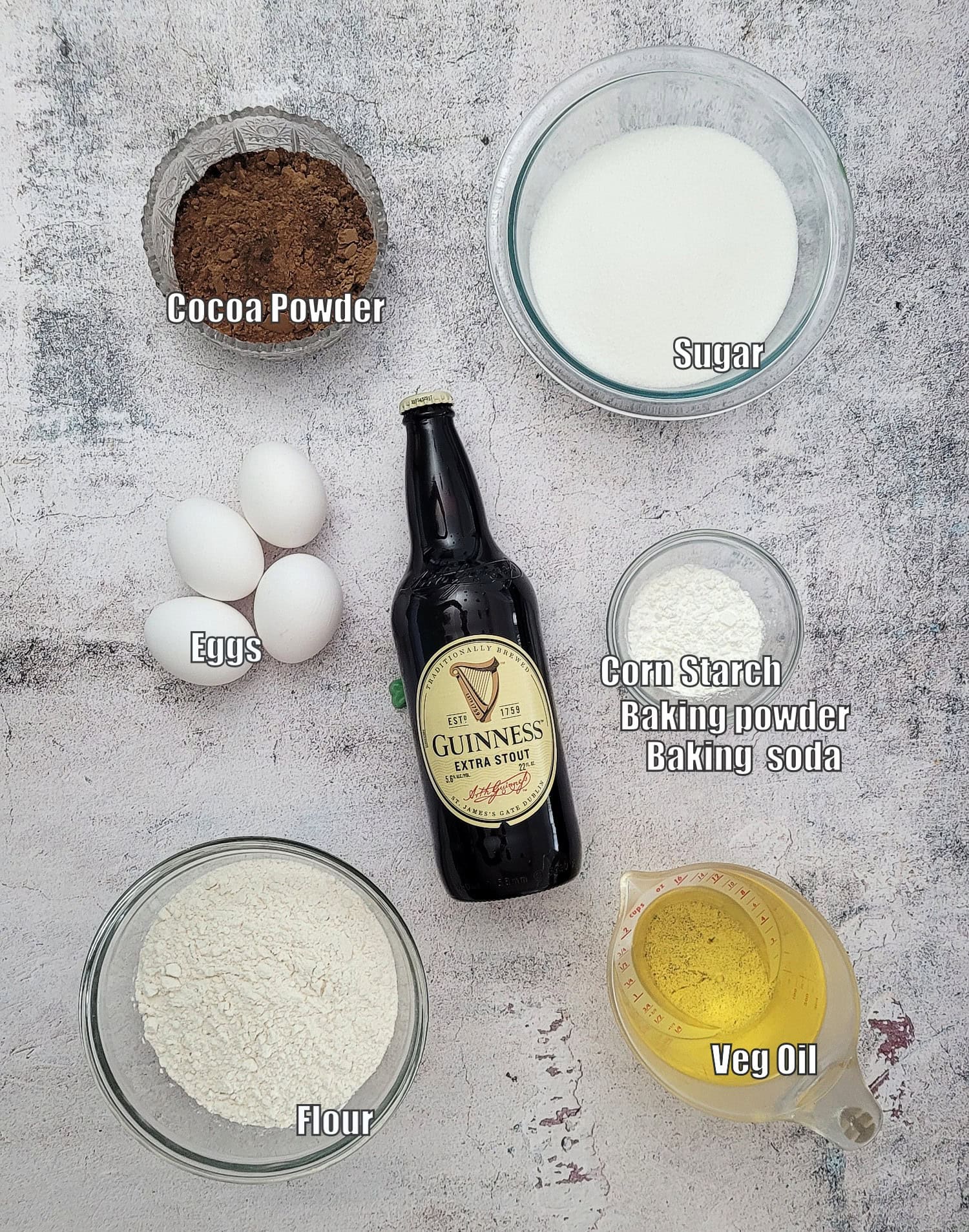 ingredients needed to make chocolate cake with Guinness including flour, cornstarch, baking powder, baking soda, cocoa powder, granulated sugar, oil, eggs and Guinness stout