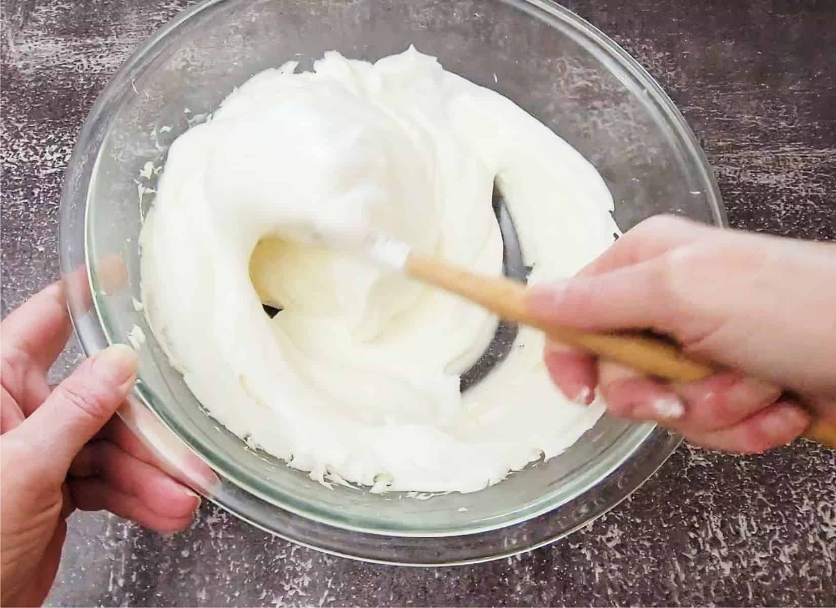 folding whipped cream into bowl as final step in making cream cheese mousse