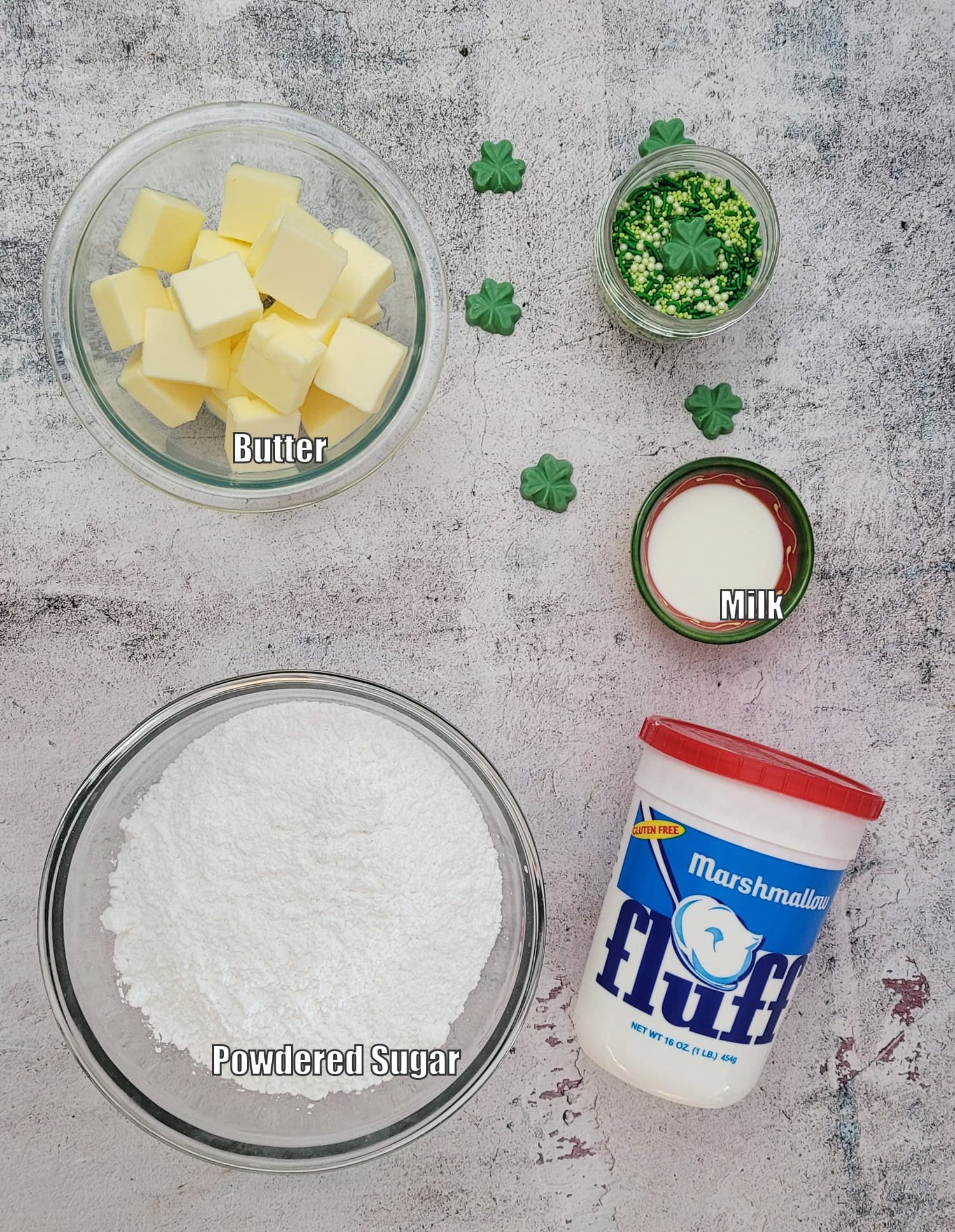 ingredients needed to make marshmallow buttercream icing including marshmallow fluff, powdered sugar, butter and milk