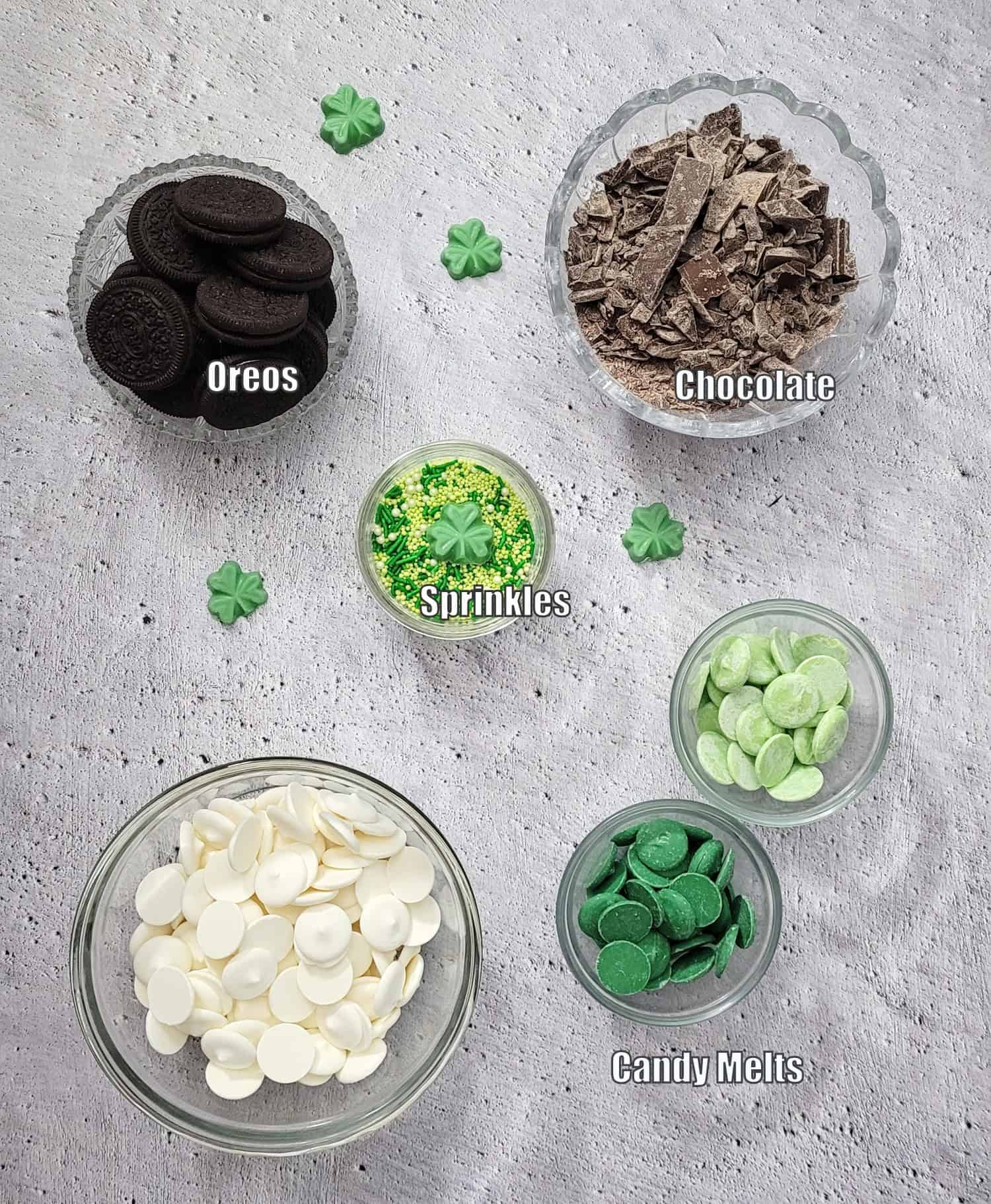 ingredients needed to make Oreo bark recipe for St. Patrick's day including chocolate, Oreos, candy melts and sprinkles