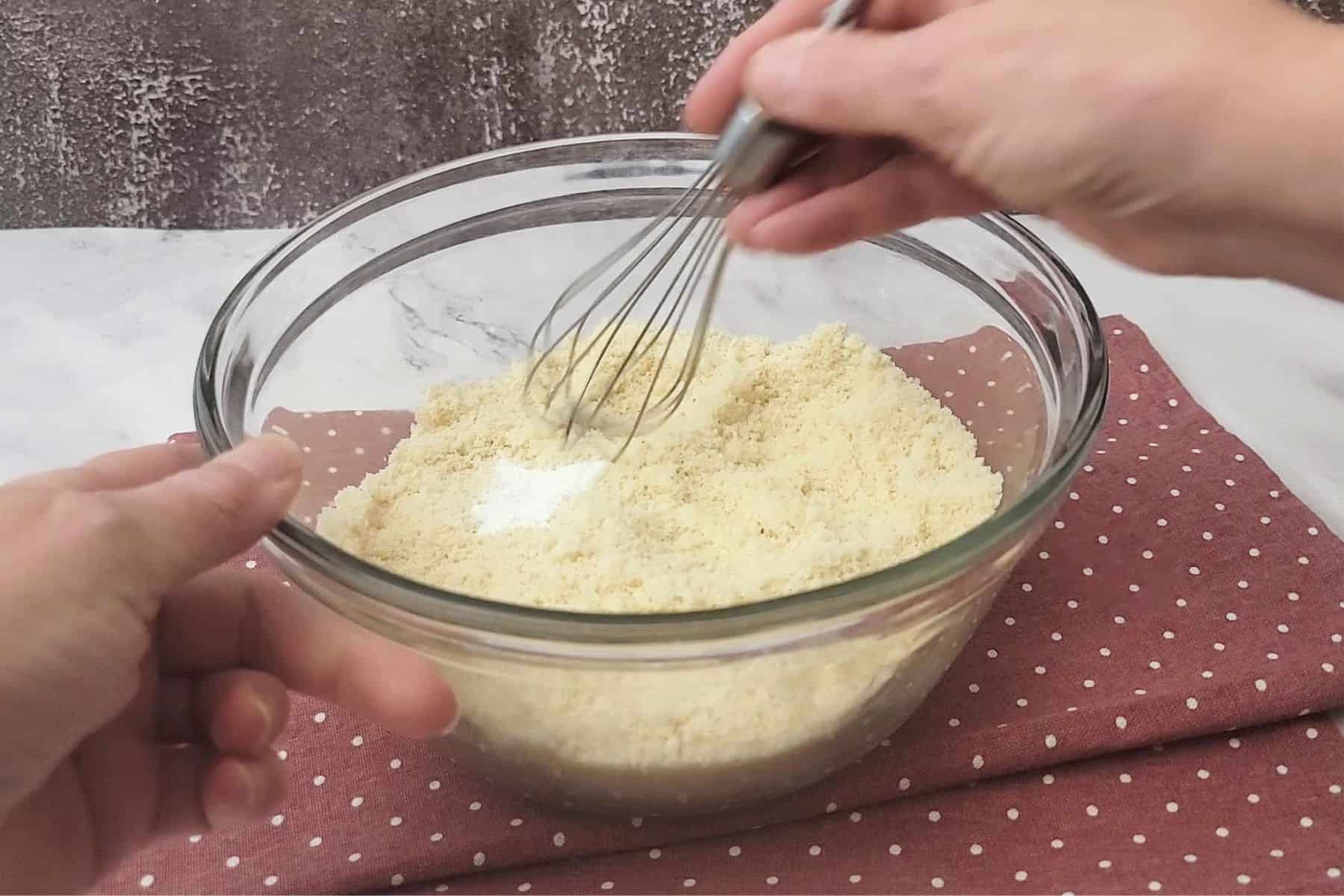 whisking together almond flour, salt and baking powder in a bowl as first step in making easy almond flour cookies