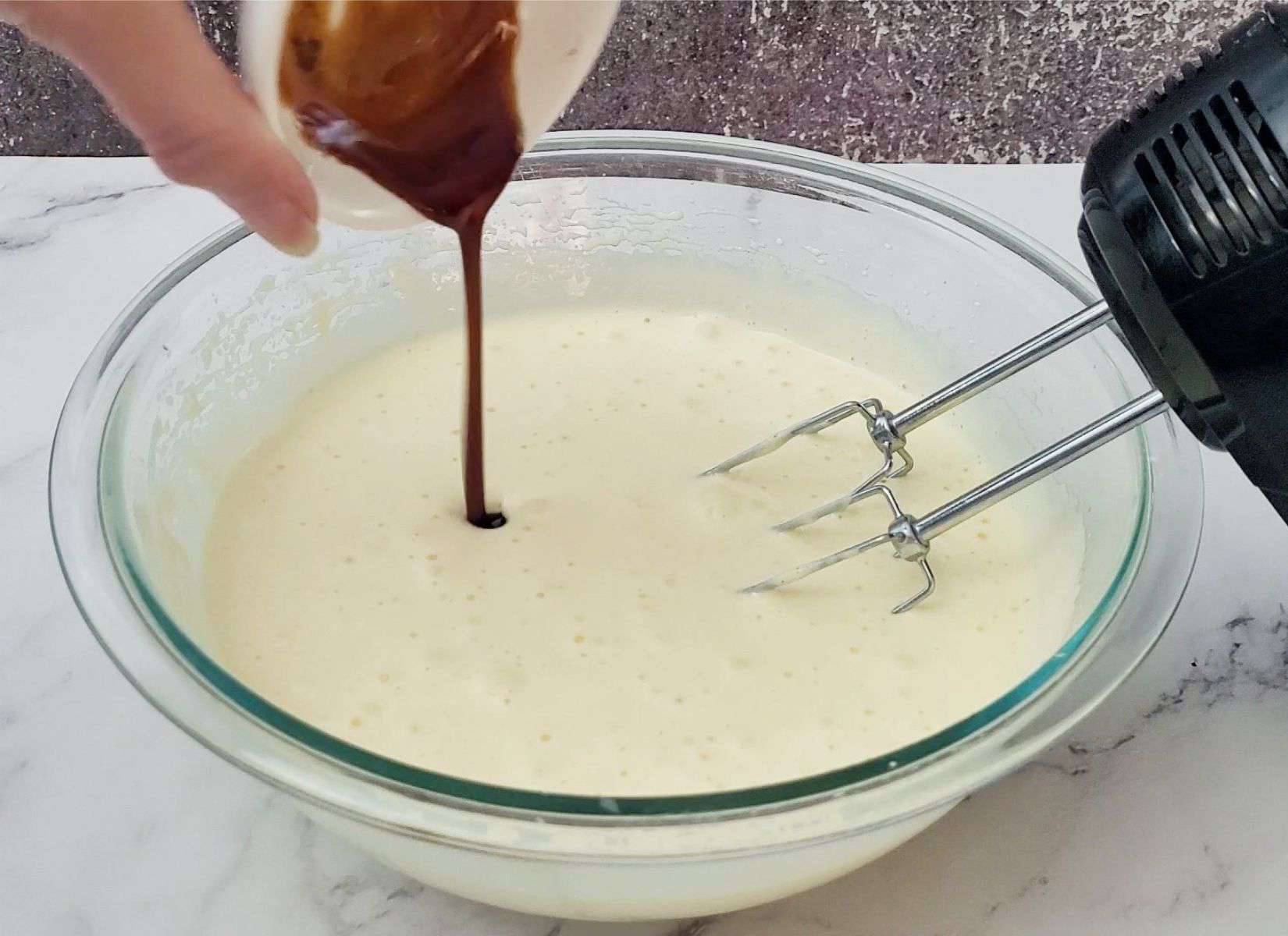 adding Amaretto flavoring to whipped eggs