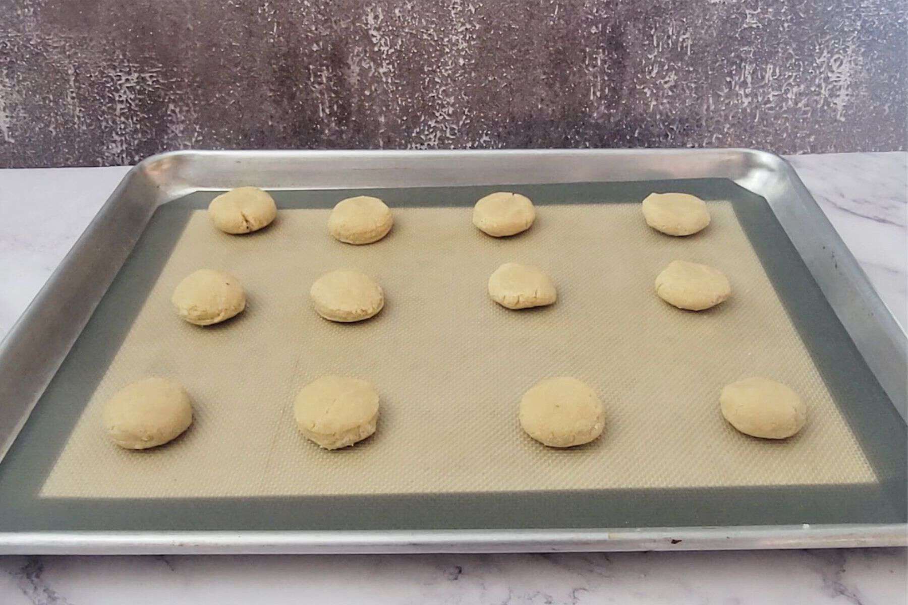 almond flour cookies on a baking sheet pan