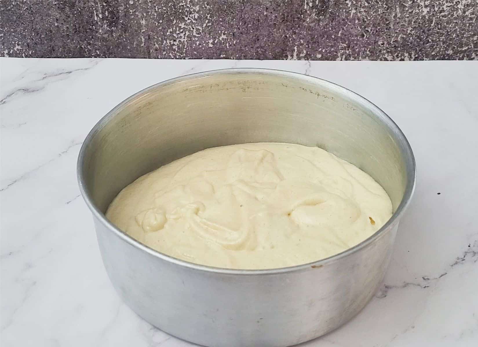 batter of cake with almond flour poured into a baking pan