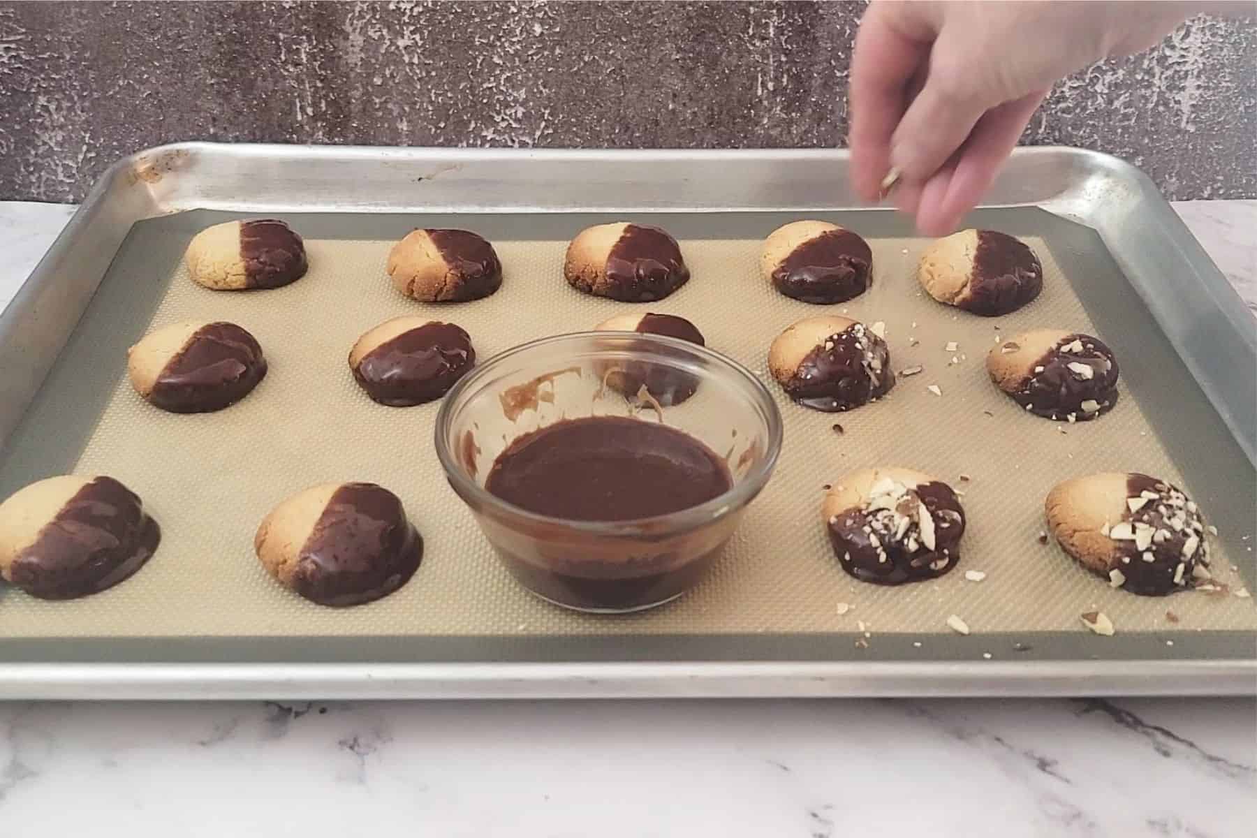 sprinkling crust almonds over cookies