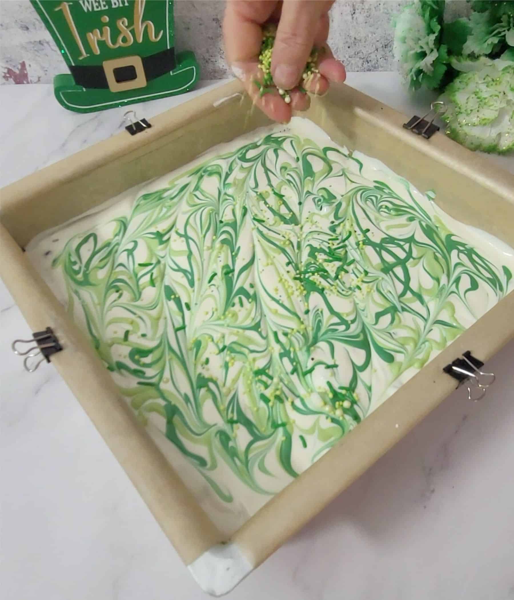 adding green sprinkles over candy bark